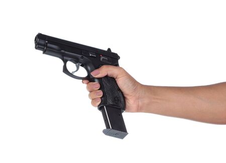 Woman's hand with a gun on a white background.の写真素材