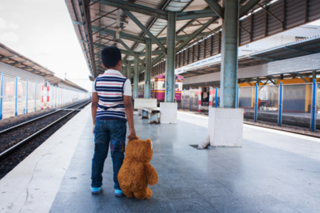 Adorable boy on a railway stationの写真素材