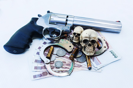 skull human with handcuff and revolver,bullet .375 on money background
