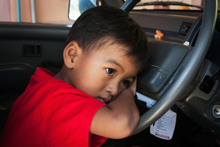 the boy sad alone in the old car,vintage toneの写真素材