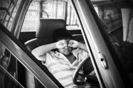 blurry of the boy sad alone in the old car,black and whiteの写真素材