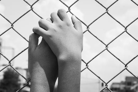 asian girl hand hold jail,black and white toneの写真素材