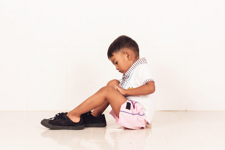 school boy wearing big shoeの写真素材