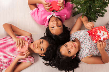 cute little  girl white gift  box and a New Year treeの写真素材