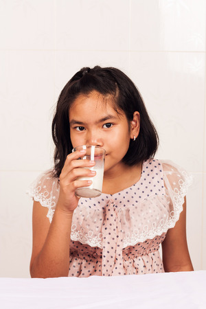 cute little girl drink milkの写真素材