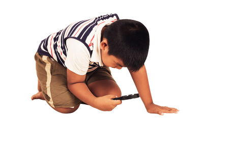 little boy play magnifying isolate backgroundの写真素材