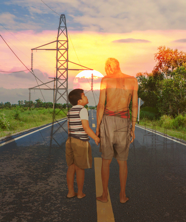 Double exposure of grandfather and grandson standing on the road sunset backgroundの写真素材