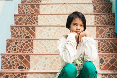 blurry,girl sad sitting alone at staircase in the parkの写真素材