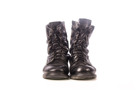 old black combat boots on white backgroundの写真素材
