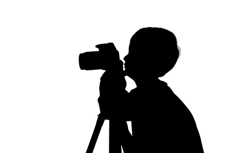 silhouette of cute little boy taking cameraの写真素材