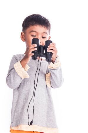little boy looking through binocularの写真素材
