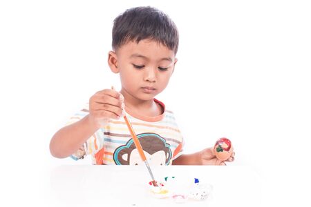 little boy play painting on faceの写真素材