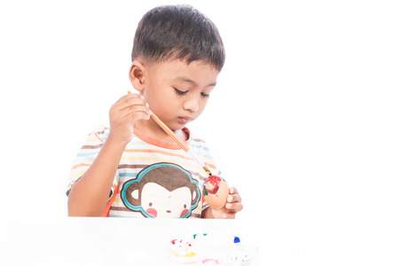 ittle boy painting easter eggの写真素材