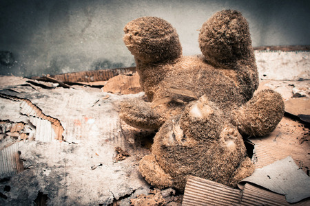Old teddy bear abandoned piles of paper,black and white toneの写真素材