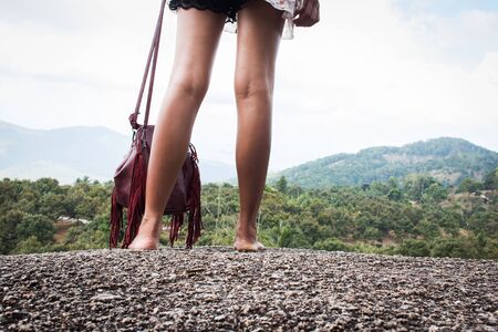 close up girl standing on the stone at top viewの写真素材