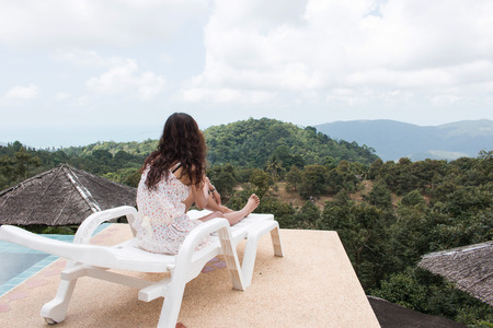 beautiful women sitting on chair  at mountain peakの写真素材