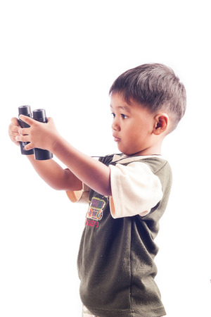 Cute little boy play binocularsの写真素材
