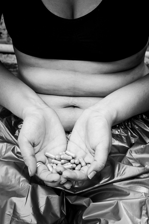 Concept weight loss,Fat women with Slim pill,black and white toneの写真素材