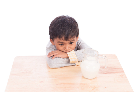 Cute little boy bored with milkの写真素材