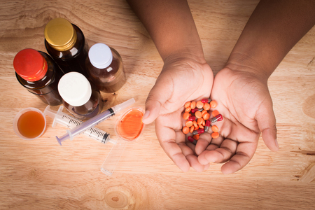 Little boy hold medicine in hand vintageの写真素材