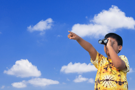 Cute little boy looking through the binocularsの写真素材