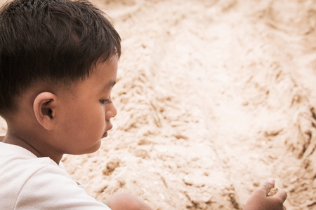 Close up of face cute little boy play sand vintage toneの写真素材