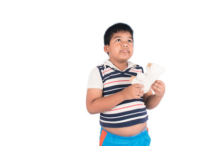 Fat boy sad standing and hold teddy bear aloneの写真素材