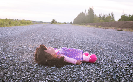 Concept Abandoned Person,Abandoned doll laying on road,vintage toneの写真素材