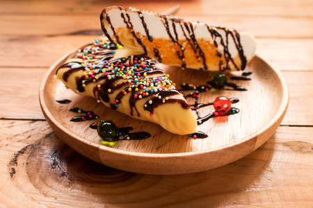 dessert with chocolate sauce on wooden plate