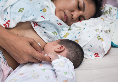 Breastfeeding Concept,mother lying breastfeeding newborn babyの写真素材