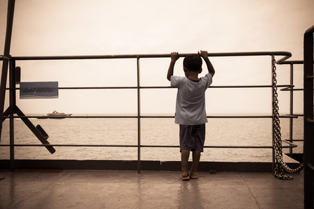 Little boy sad standing and hand hold cage,old photo vintage toneの写真素材