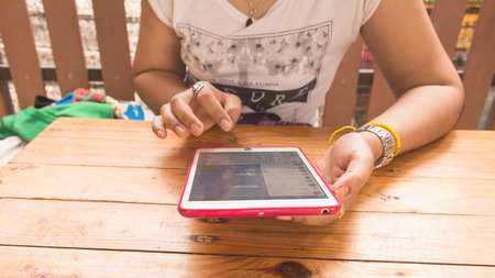 Teen women use smartphoe in shopの写真素材