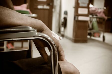 patient sitting on wheelchair in hospital vintage toneの写真素材