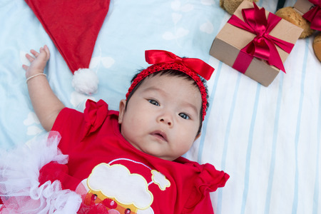 Cute little girl newborn with decorating Christmas tree