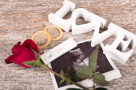 concept valentine day,red rose and test love on brown wooden background,vintage toneの写真素材