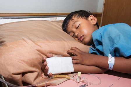 little boy sick sleep on patient  bedの写真素材