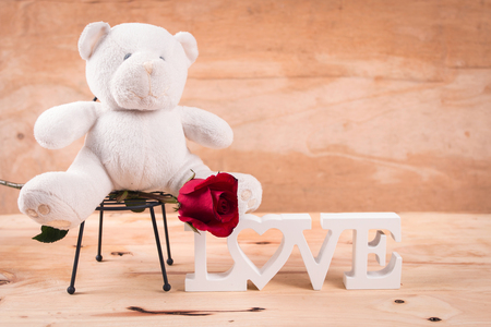 concept valentine day,red rose and test love on brown wooden backgroundの写真素材