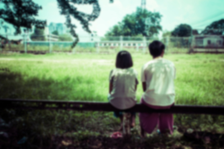 Blurry fo Asian girl sitting in the park vintage toneの写真素材