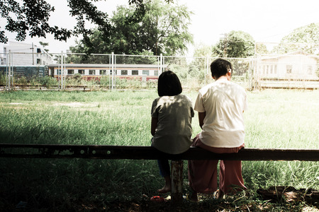 sad girl sitting in the park vintage toneの写真素材