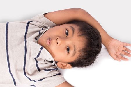cute asian little boy lying on floor の写真素材