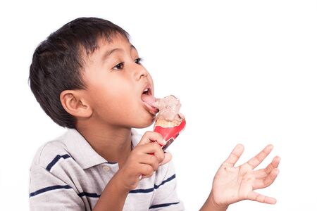 Cute haapy asian little boy eat ice creamの写真素材