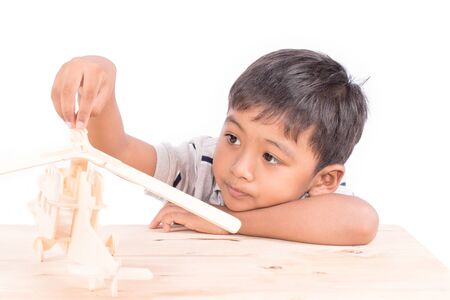 Cute asian little boy play plane toy woodの写真素材