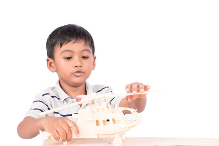 Cute asian little boy play plane toy woodの写真素材
