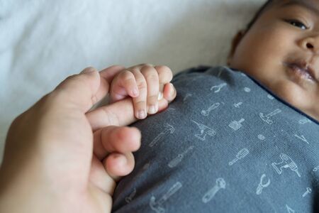 close up of hand mom hold hand babyの写真素材