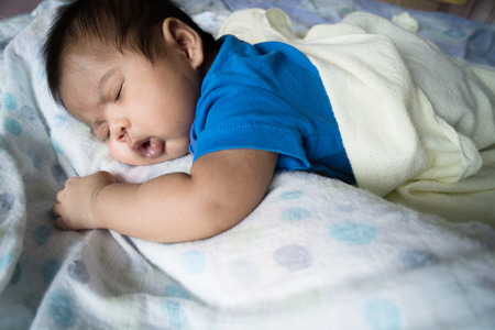 Cute asian baby sleepingの写真素材