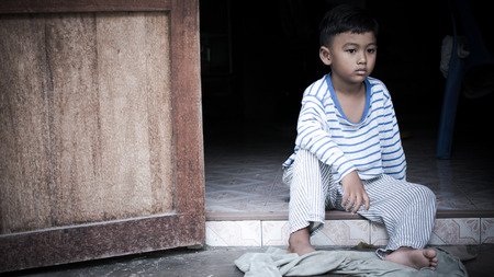 poor asian boy  sad alone,vintage toneの写真素材