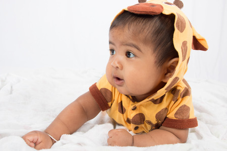 cute asian baby lying on floorの写真素材