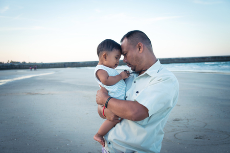 Happy Dad and son play on the beachの写真素材