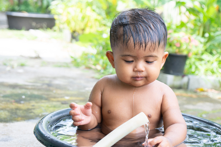Cute little baby boy take a bathの写真素材