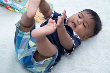 Cute little asian baby boy lying on soft blanket